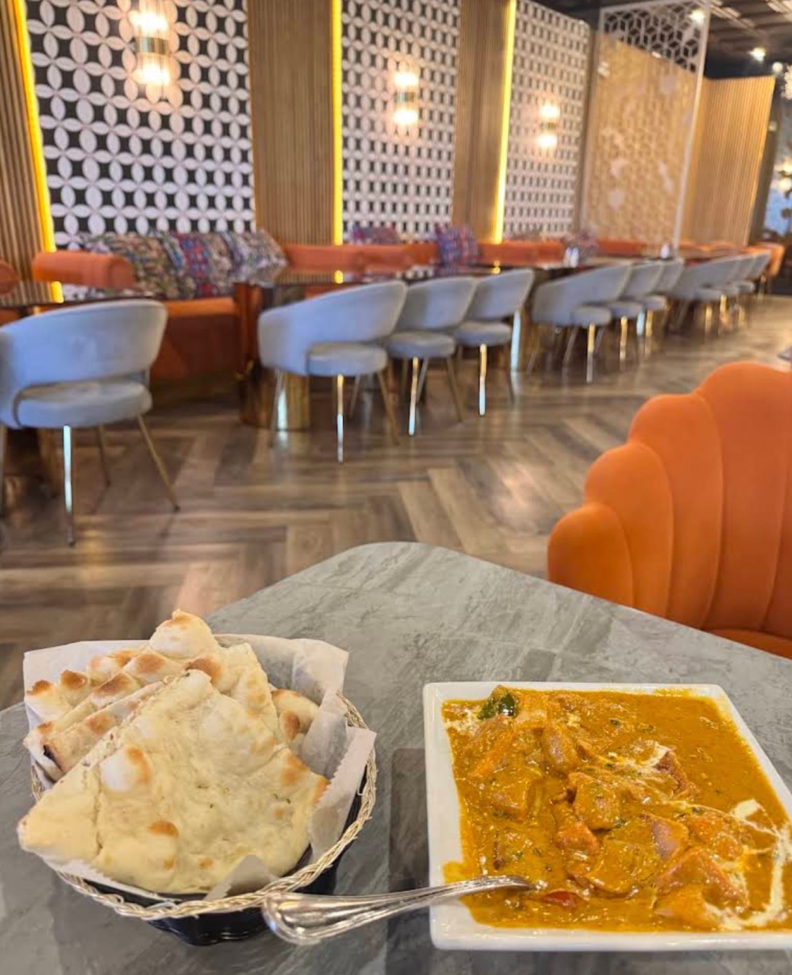 Naan and curry with the dining room in warm focus behind