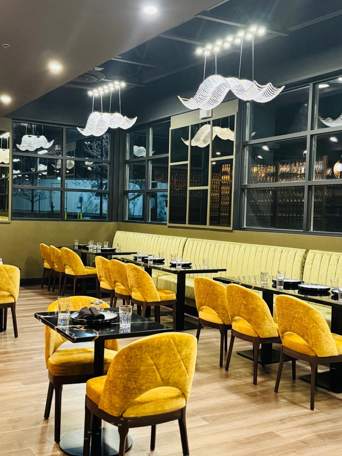 Dining room with mustard velvet chairs and scallop chandelier