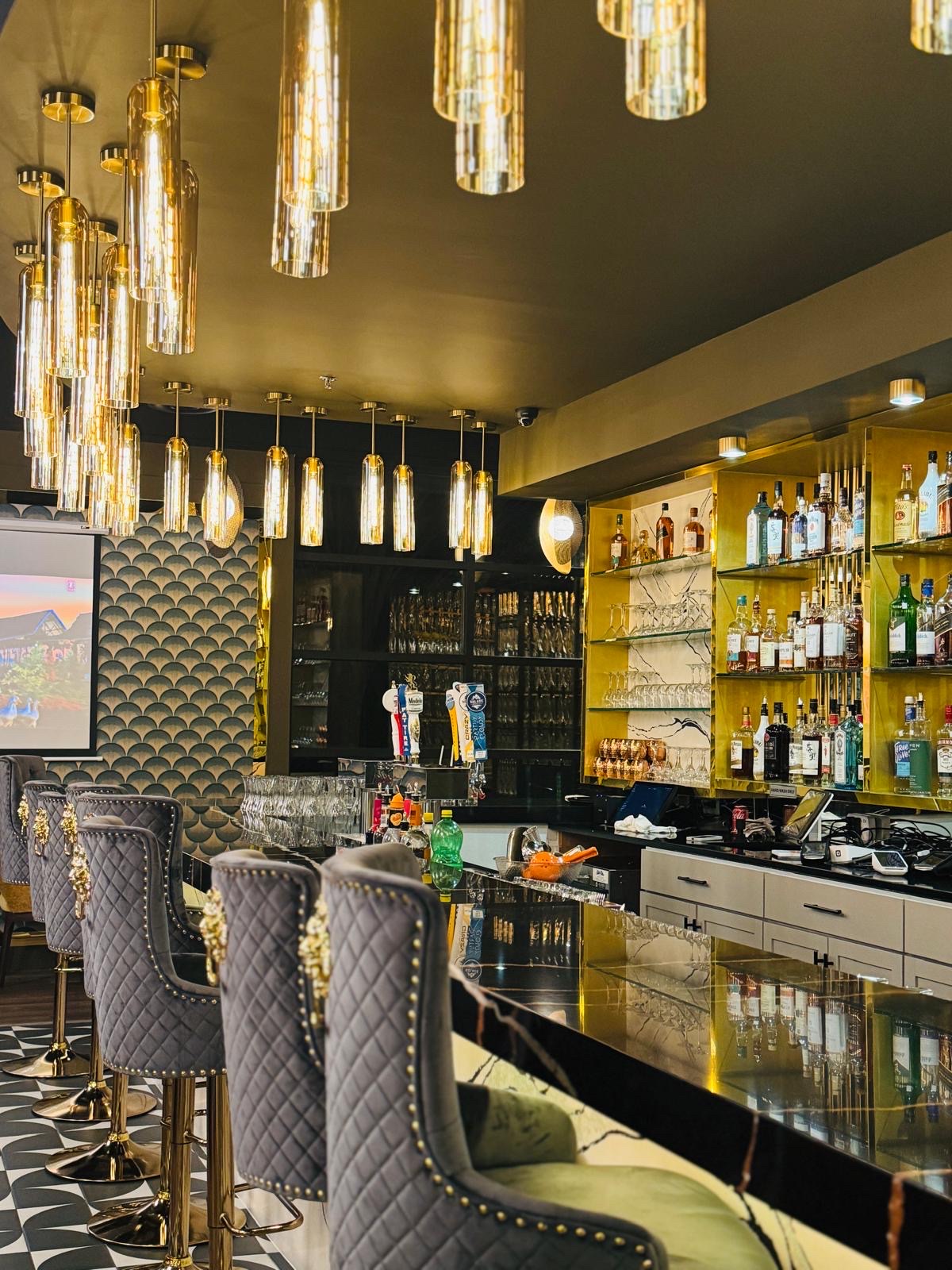 Gold bar with cascading crystal tube pendant lights