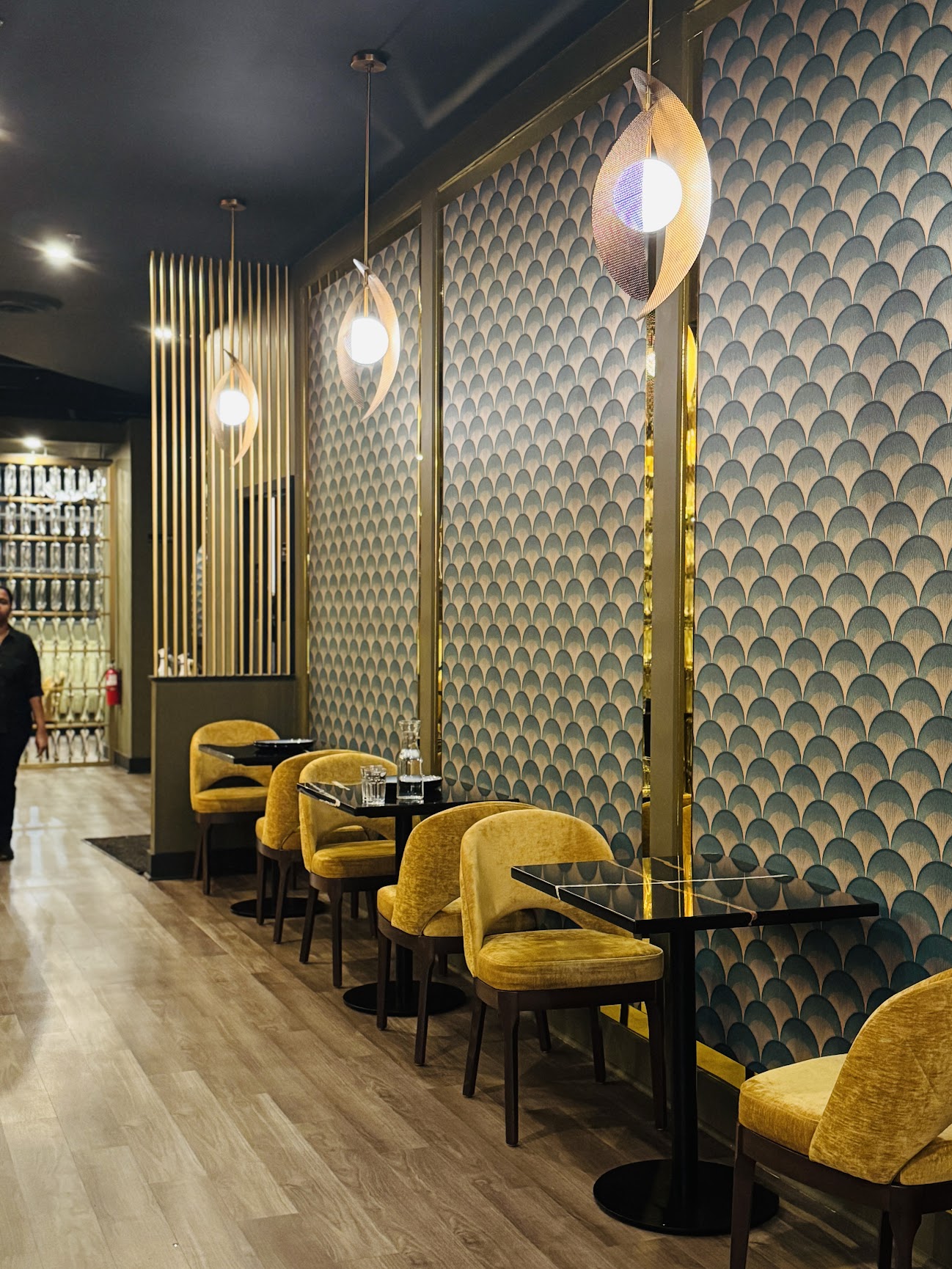 Art deco scallop wallpaper with pendant light and yellow seating