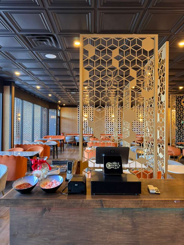Mughal jali partition with warm dining room beyond